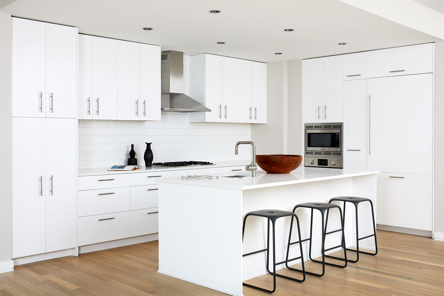 Savor european-inspired, all white flat-front wood cabinets.