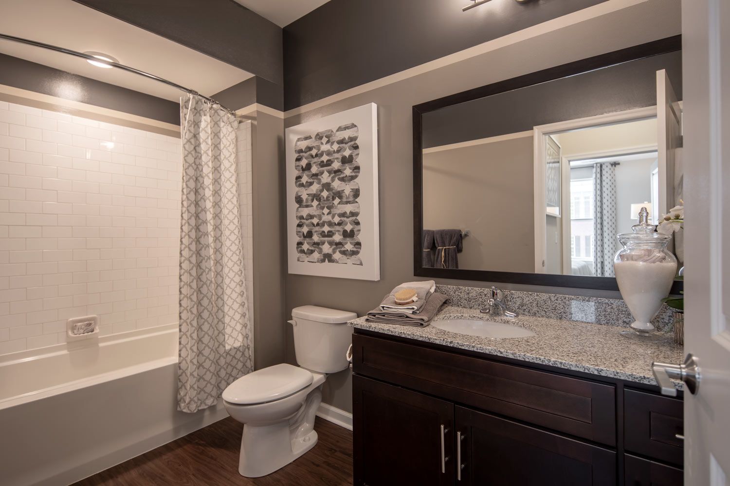 Granite counterops and subway tile backsplash in each bath.