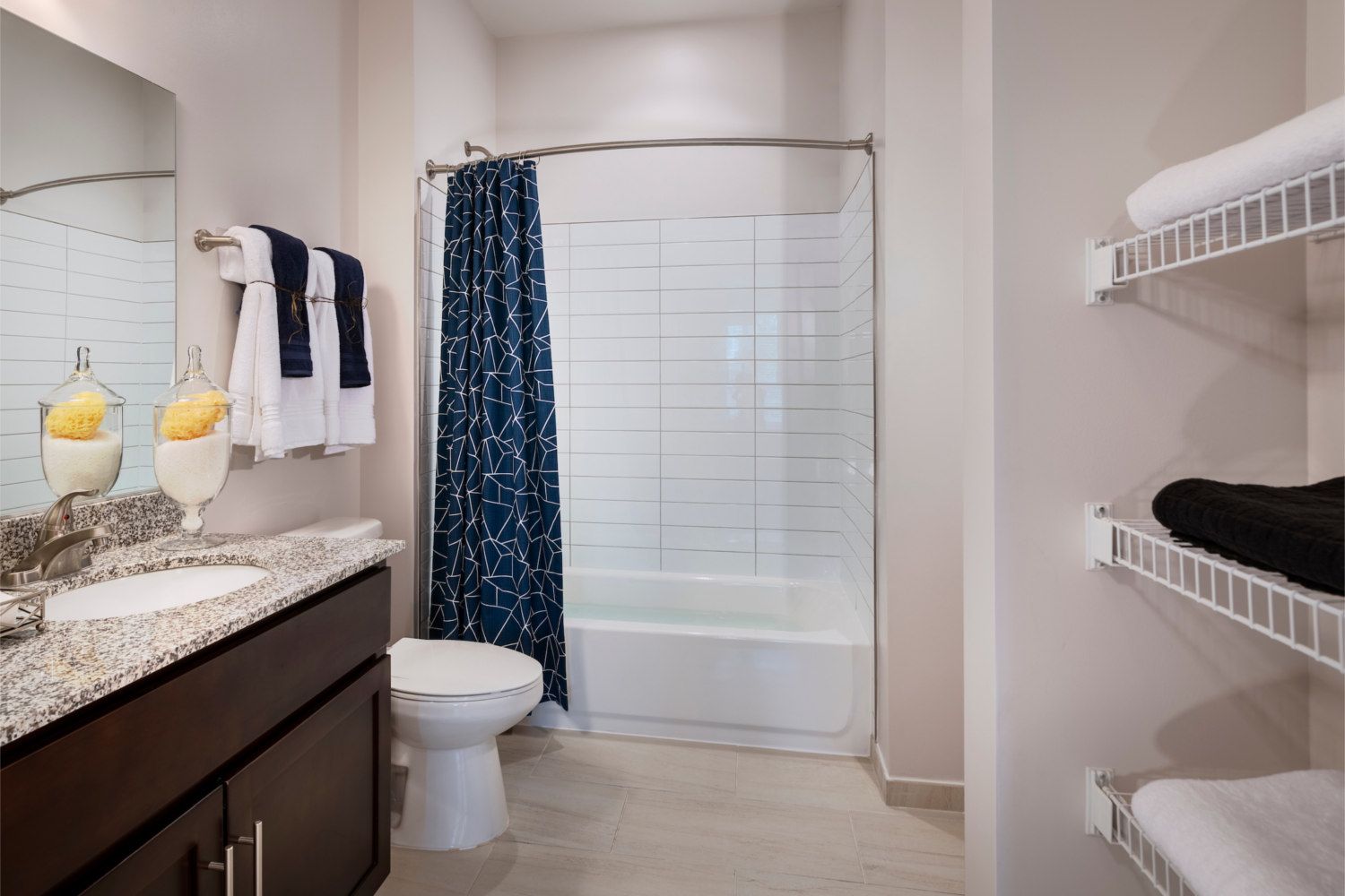 Each bathroom features subway tile backsplash and rich cabinetry.
