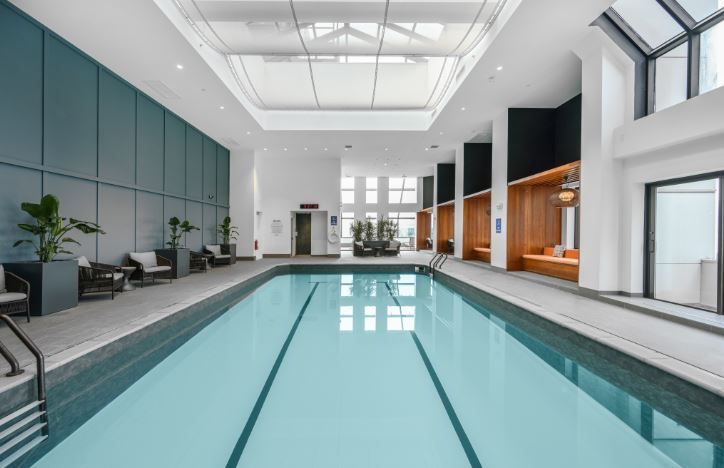 Indoor swimming pool with modern architecture and natural light.