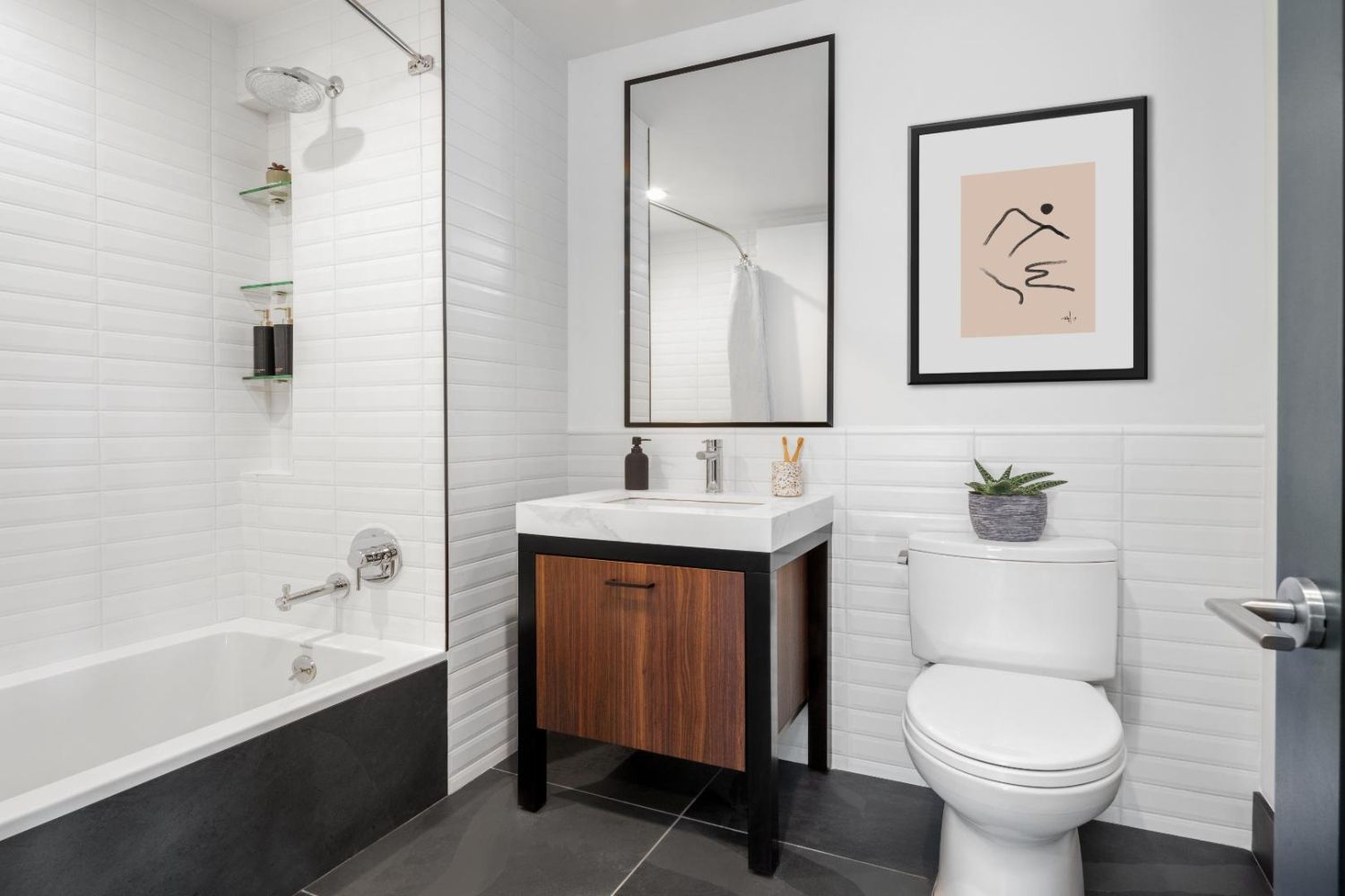 Modern bathroom featuring a shower-bath combo, vanity, mirror, and art on the wall.