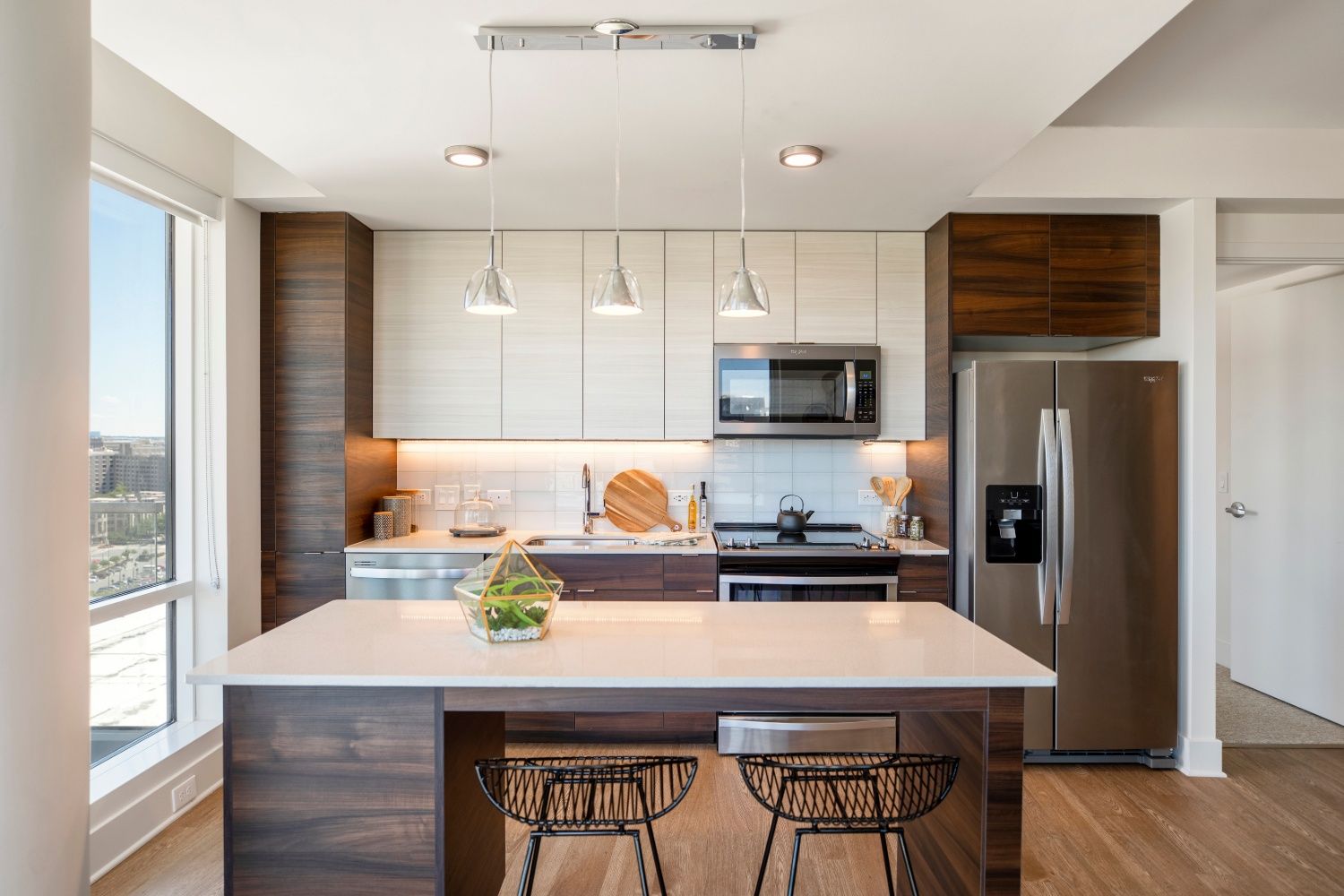 Darkwood cabinets and white granite on stainless steel