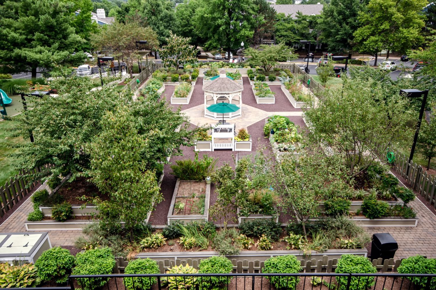Aerial view of a landscaped garden with pathways, greenery, and a central fountain.