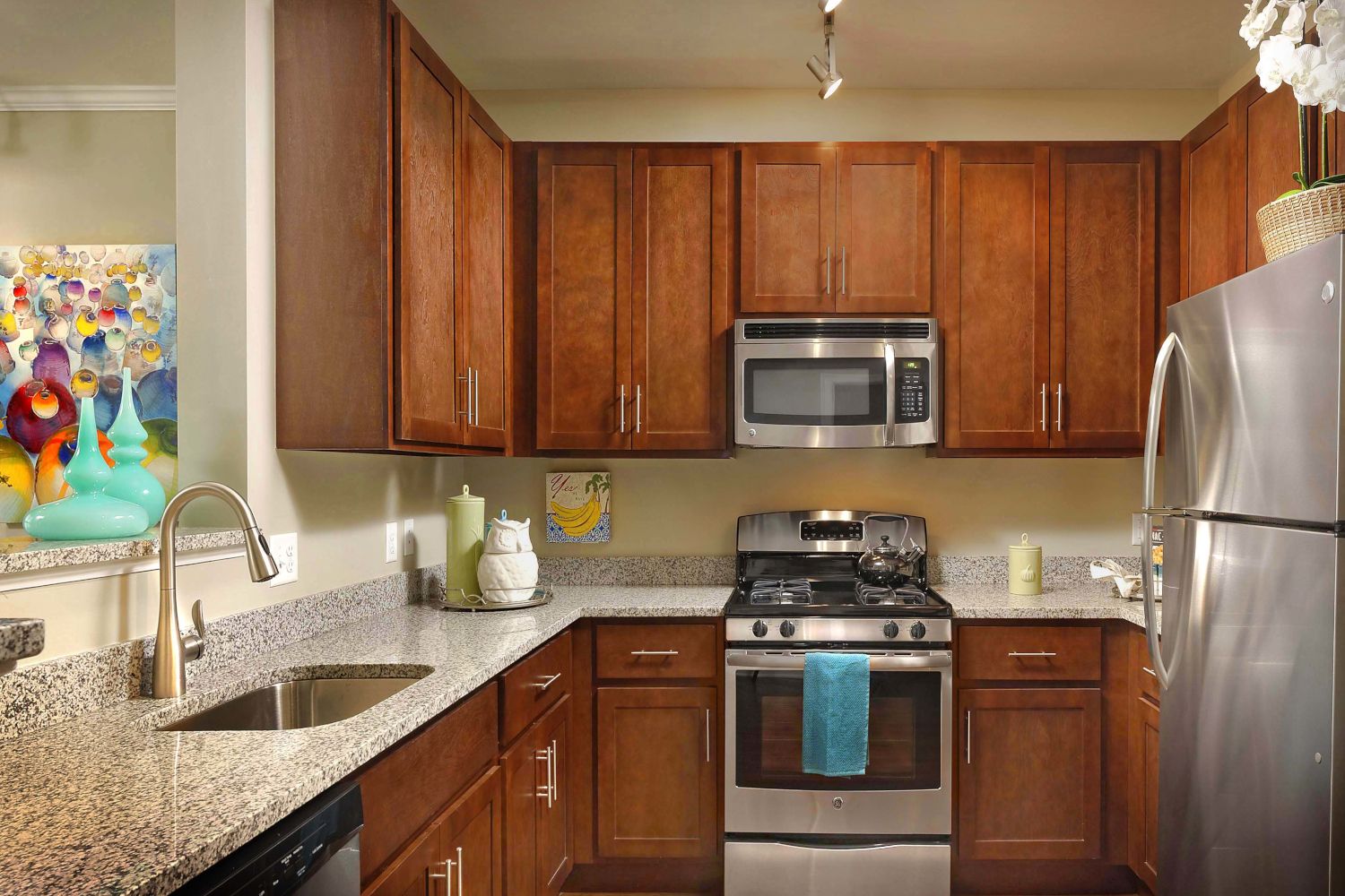 A chef's dream kitchen awaits with shaker-style cabinets, a stainless steel appliance package, and granite countertops.
