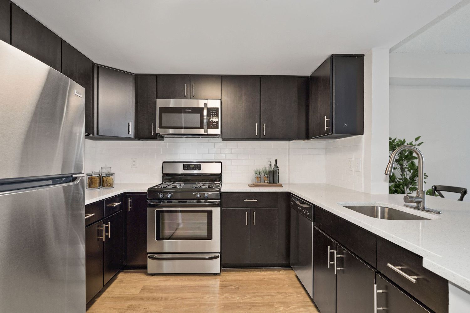 White quartz counters and dark espresso cabinets create an elegant juxtaposition