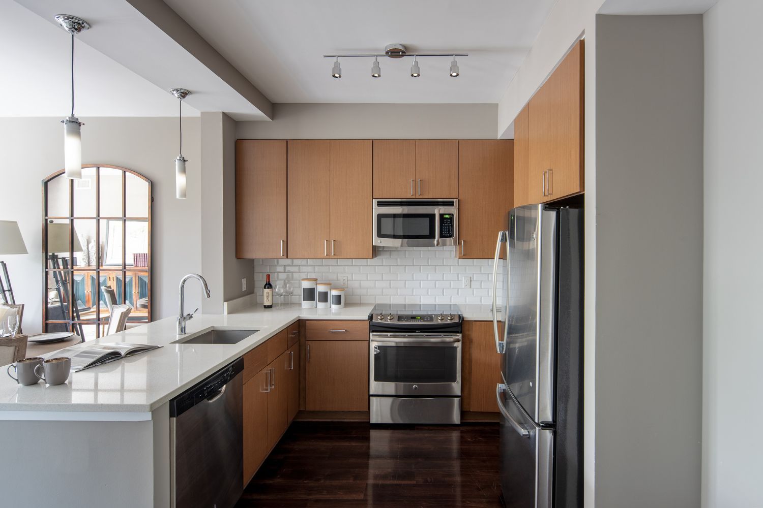Refined kitchens featuring white quartz countertops and stainless steel appliances
