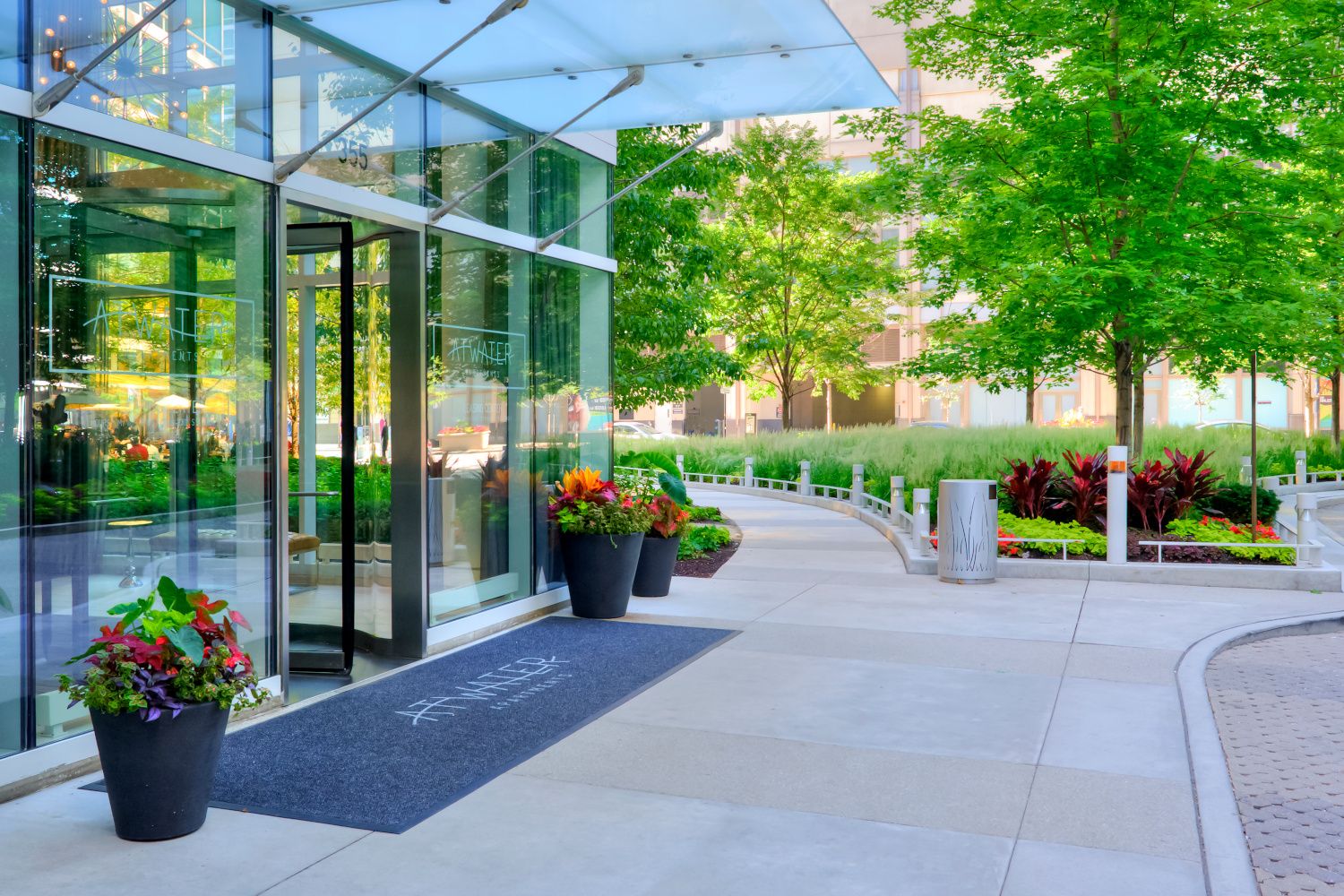Side angle of Atwater's entrance with lush foliage in the background.