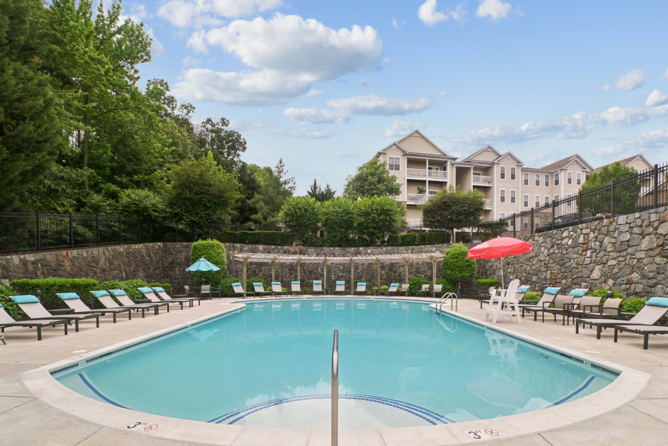 Community outdoor pool with ample lounge seating