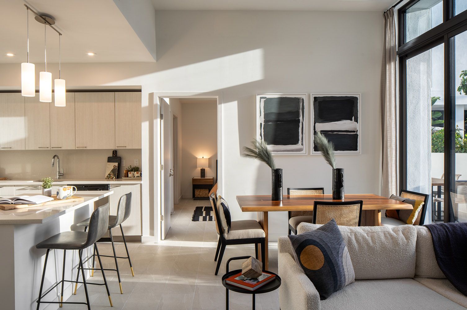 Bright, modern living space with a dining area, kitchen, and cozy seating.