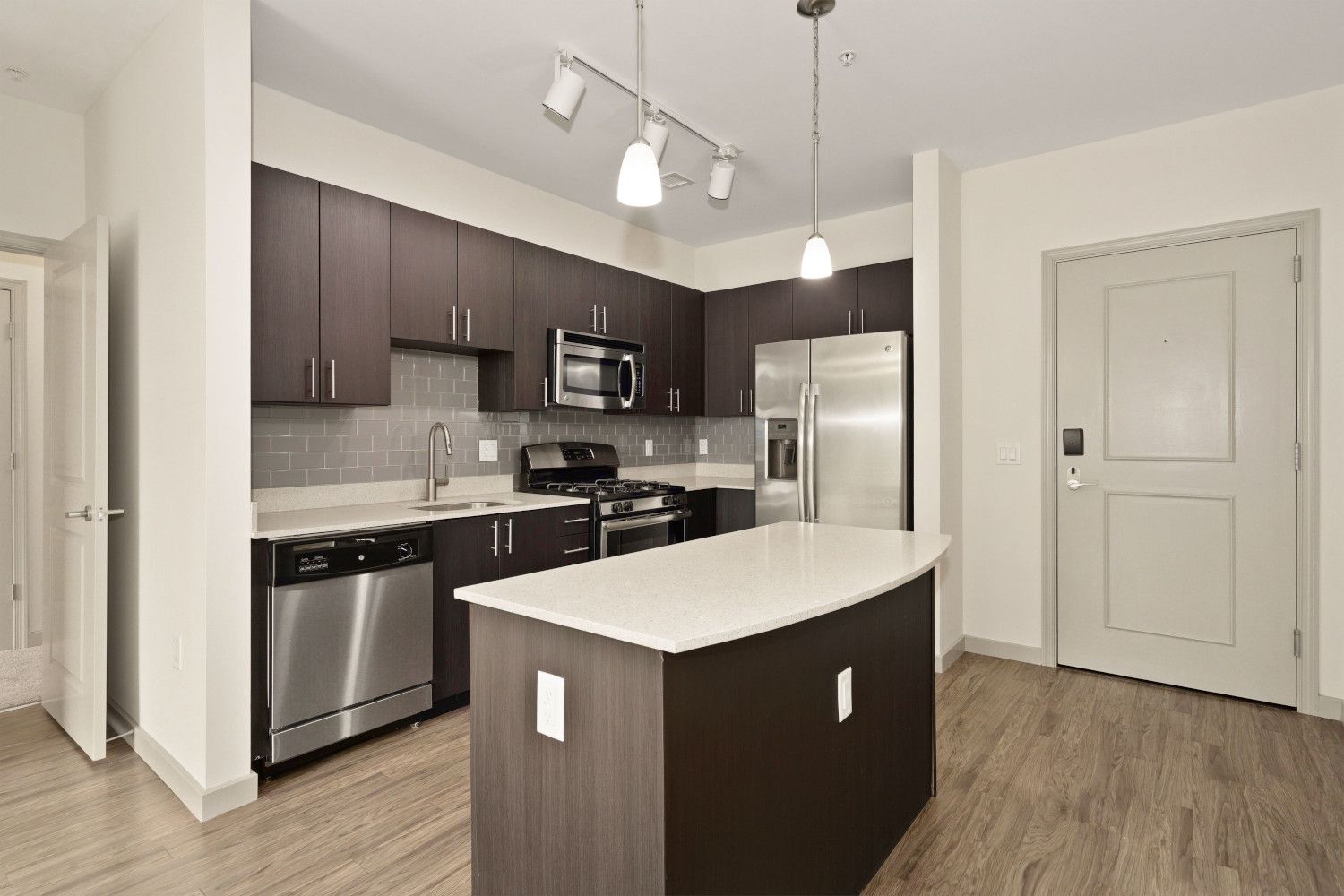 Kitchens with stainless steel appliances, ample cabinet storage, and modern tile backsplash