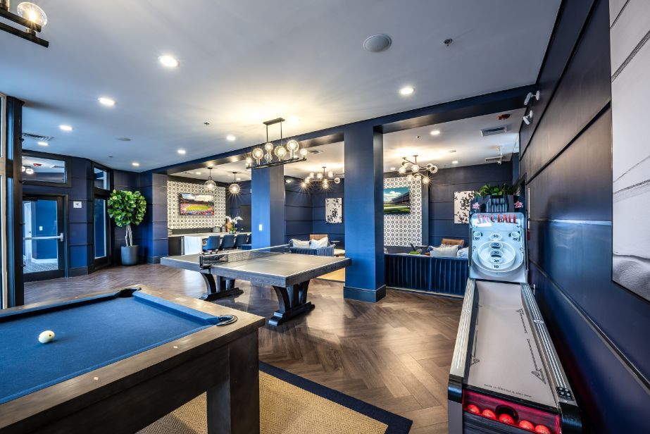 Modern recreational room with a pool table, air hockey, and stylish decor.