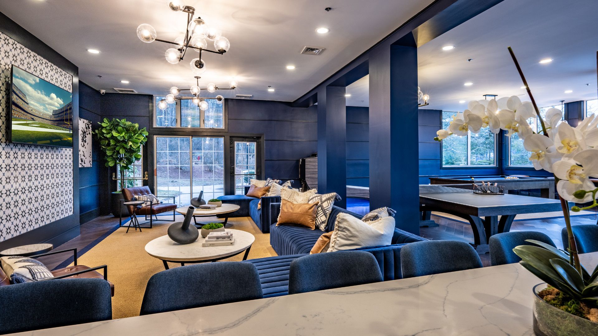 Modern lounge area with blue accents, comfortable seating, and decor elements.