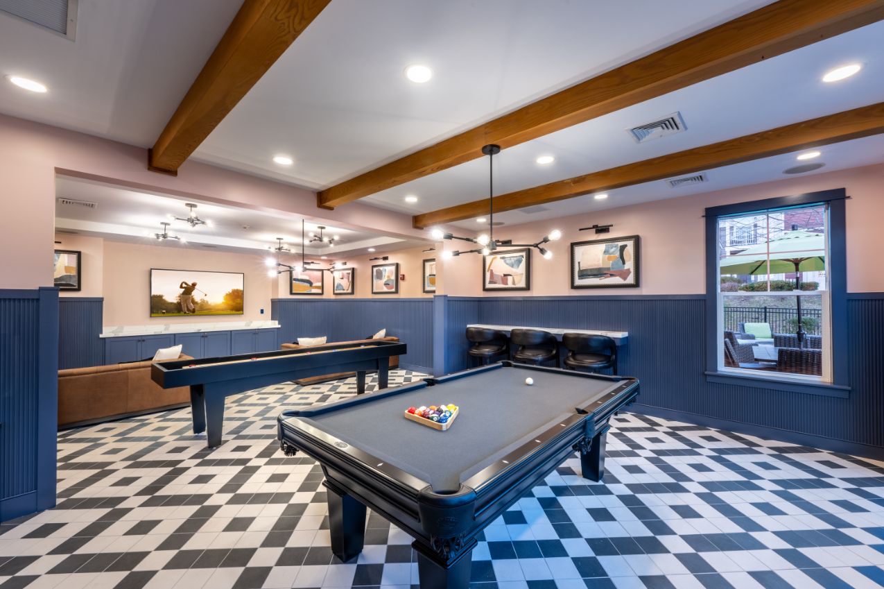 Modern game room with pool tables and stylish decor.