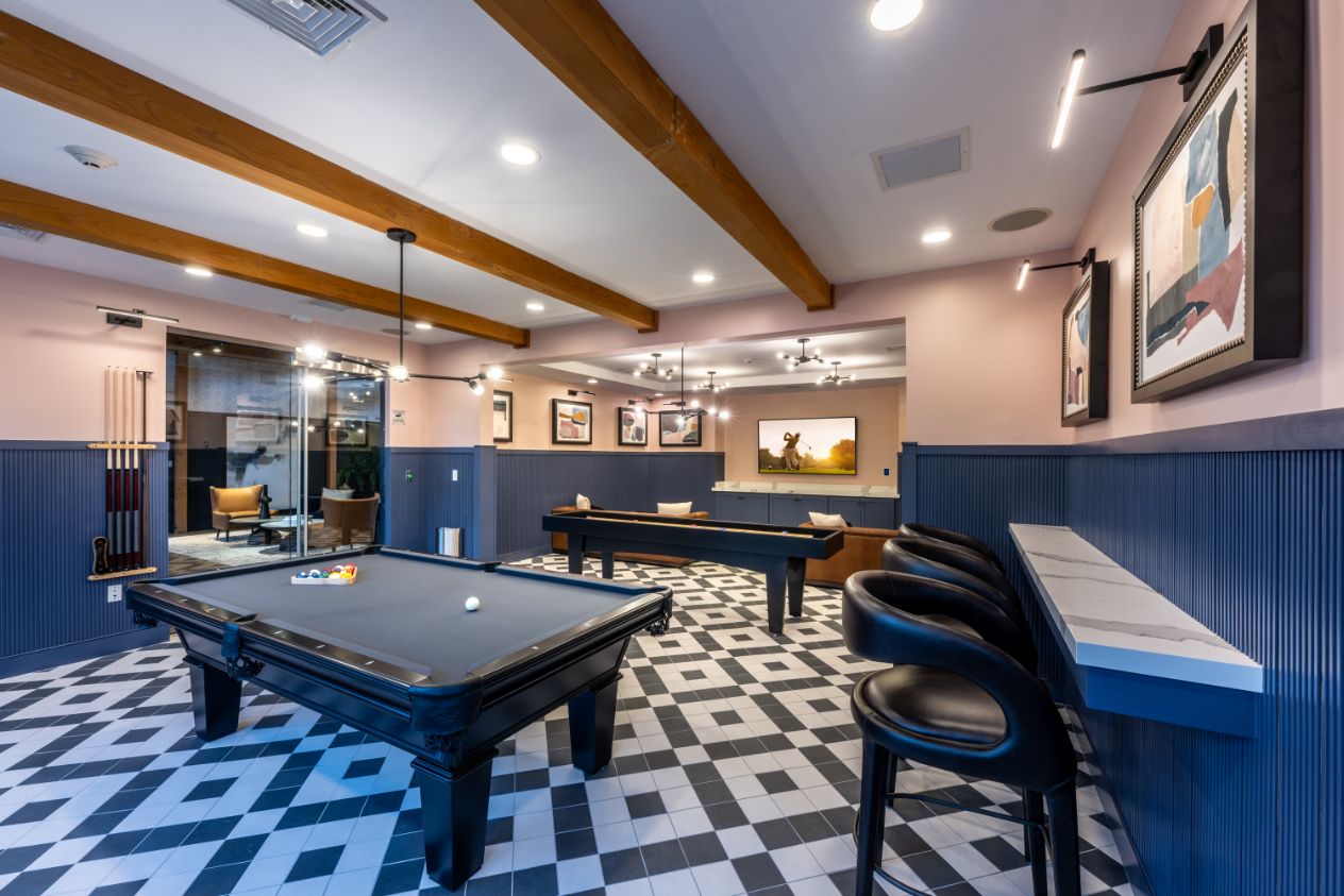 Modern game room with pool tables and stylish decor.