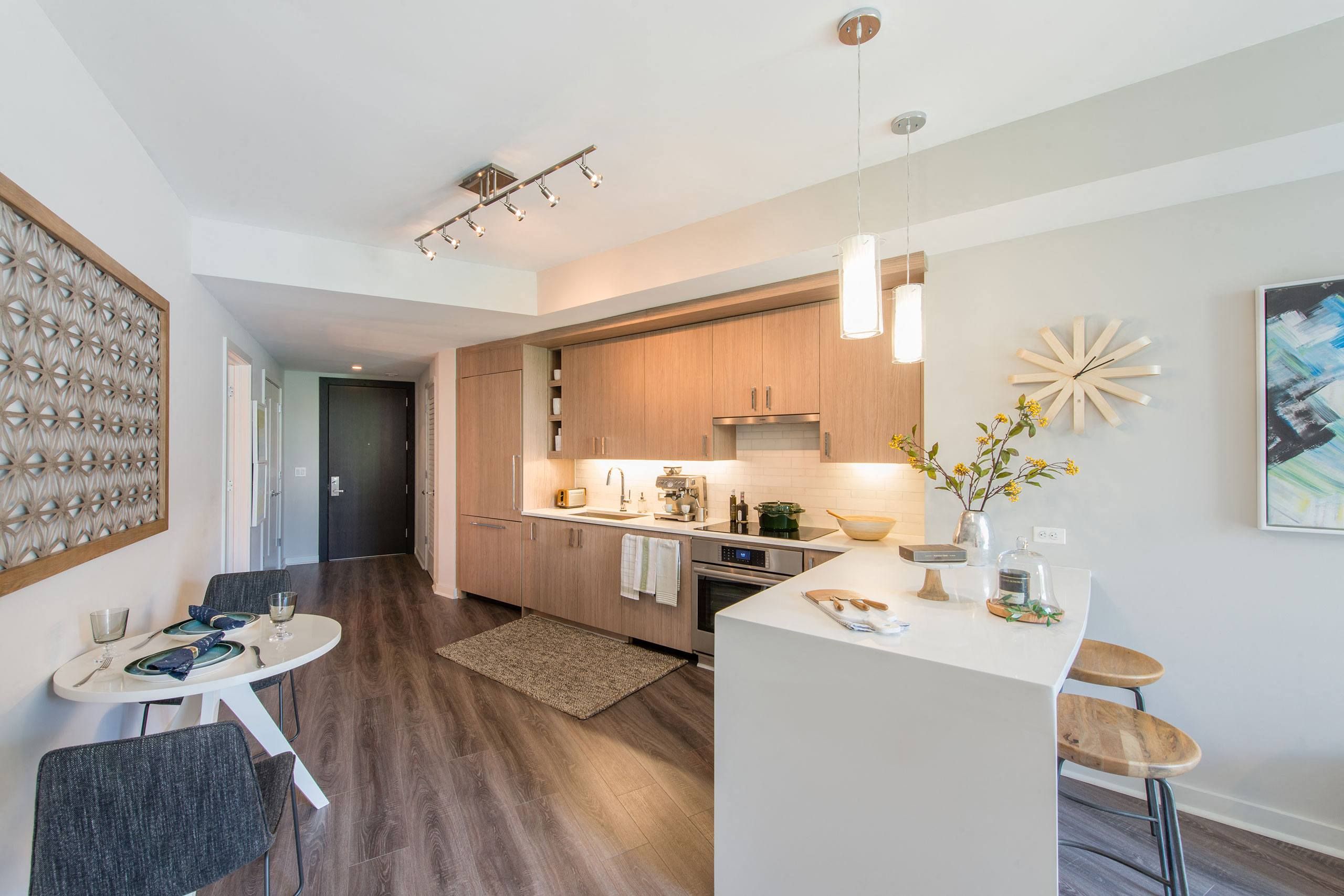 Modern open-concept kitchen and dining area with wooden accents and stylish decor.