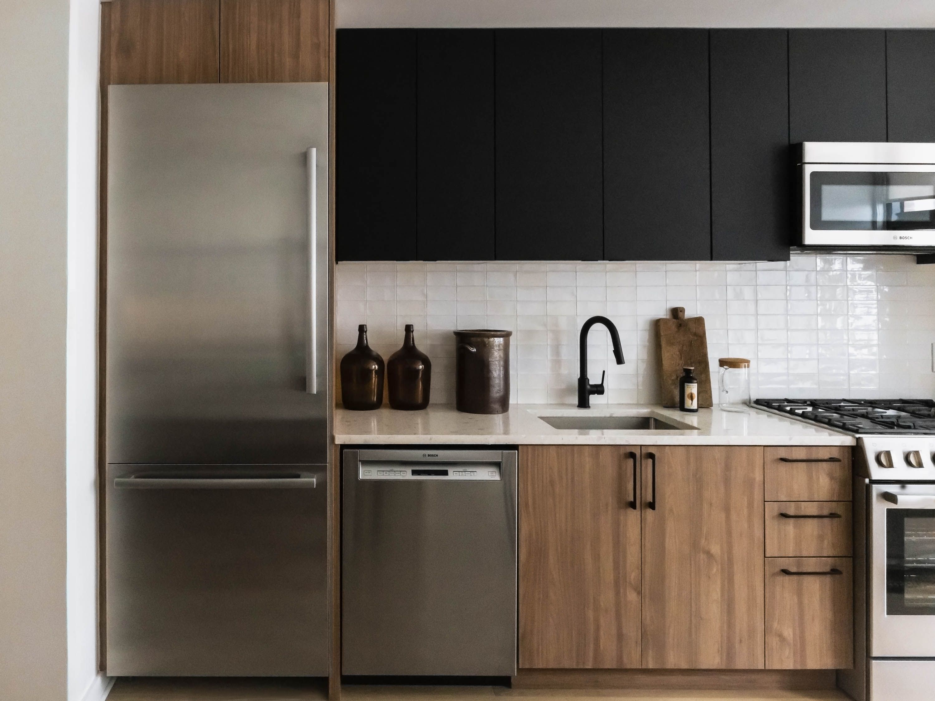 Modern kitchen with stainless steel appliances and wooden cabinetry.