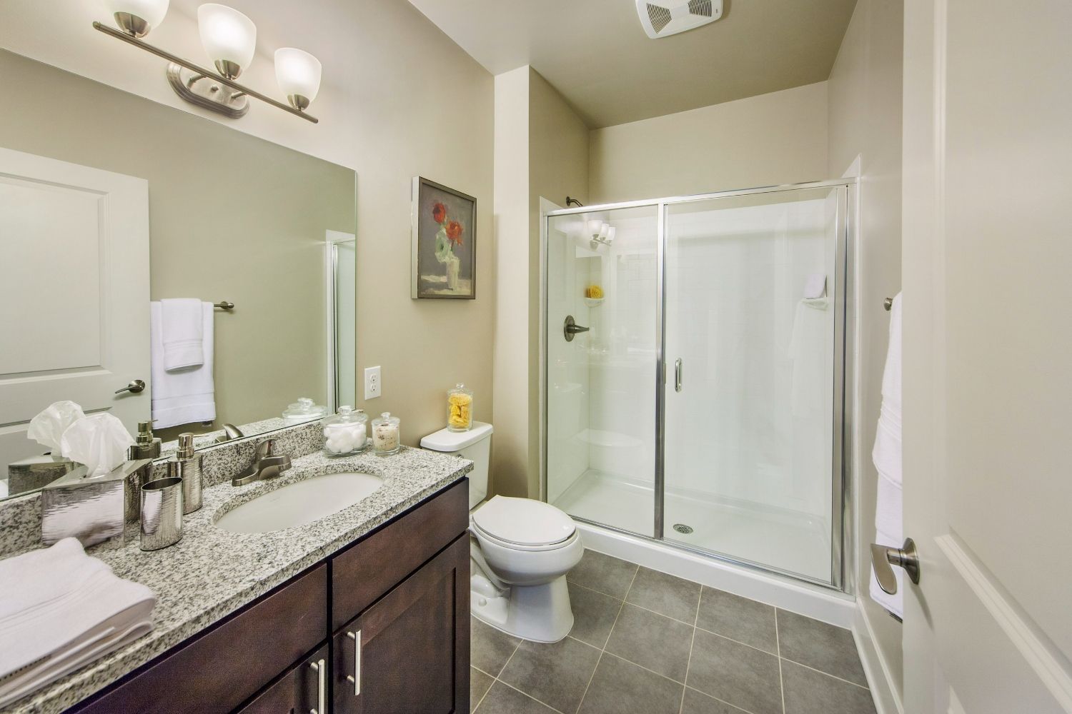 Clean bathroom with shower, sink, and modern decor.
