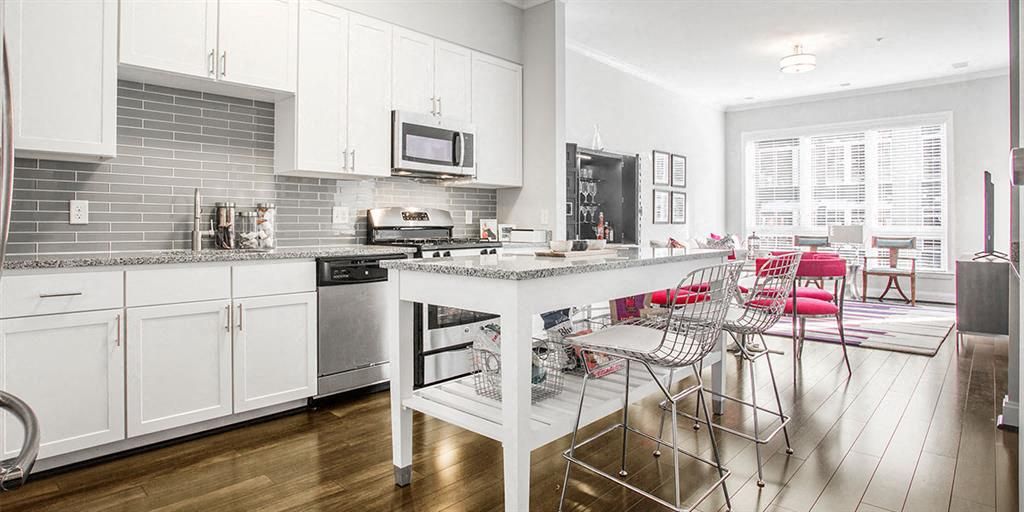 Modern kitchen and dining area with white cabinets and a bright, open layout.
