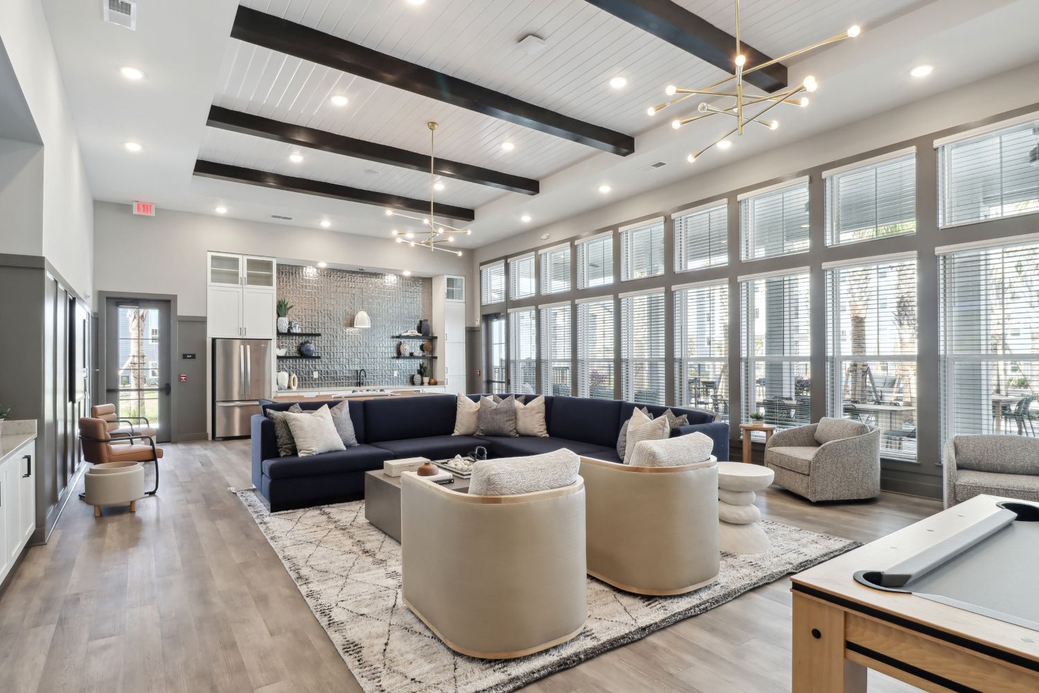 Entertain in the expansive clubroom, complete with a large flat screen TV, pool table, kitchen, and outdoor covered lanai with stunning views.
