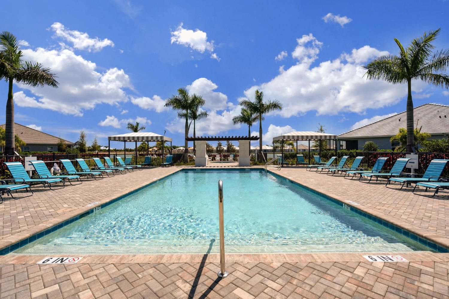 Lounge by the resort-style pool with an abundance of seating
