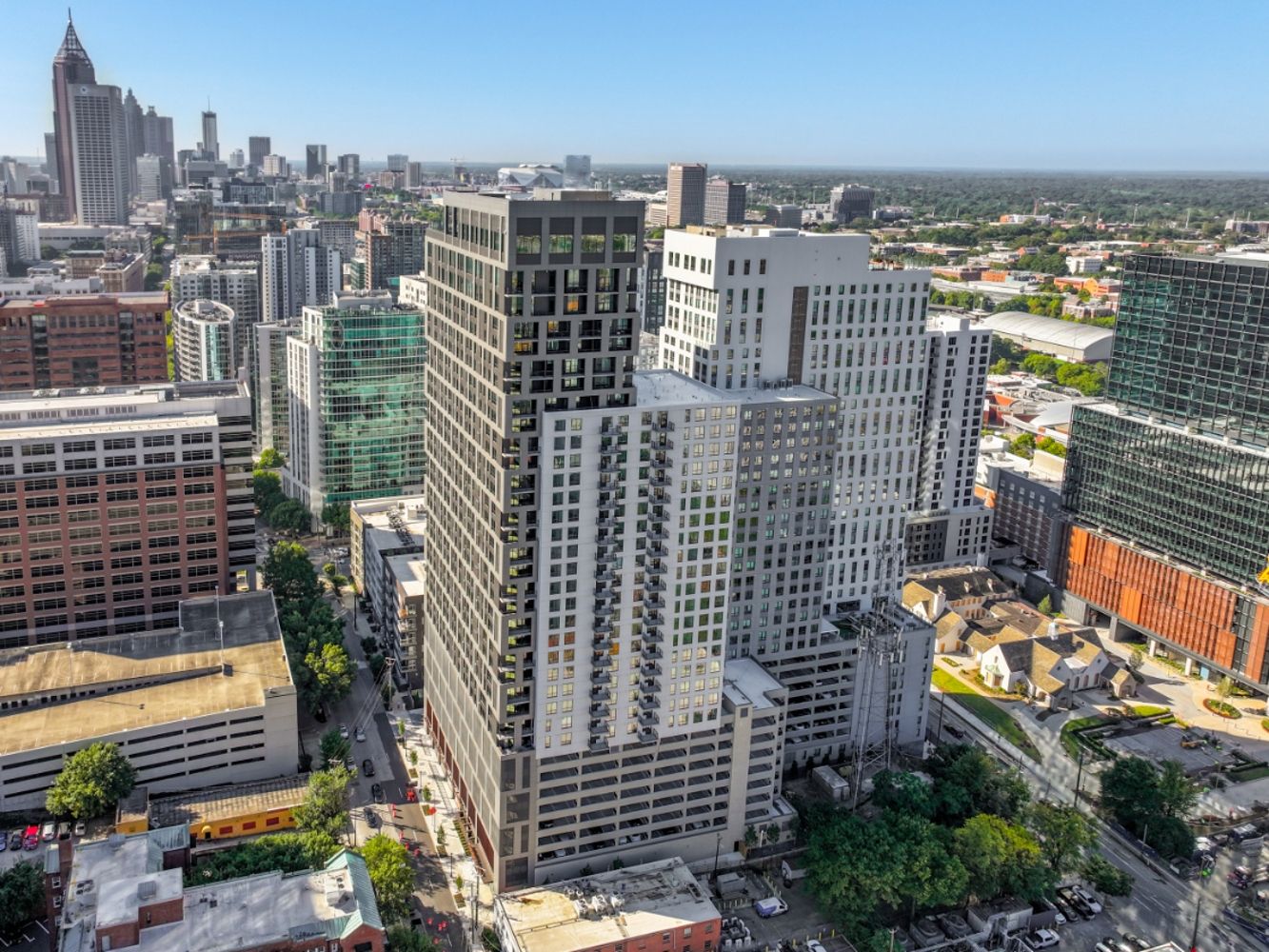 High-rise apartment towers in downtown cityscape with skyline and blue sky background