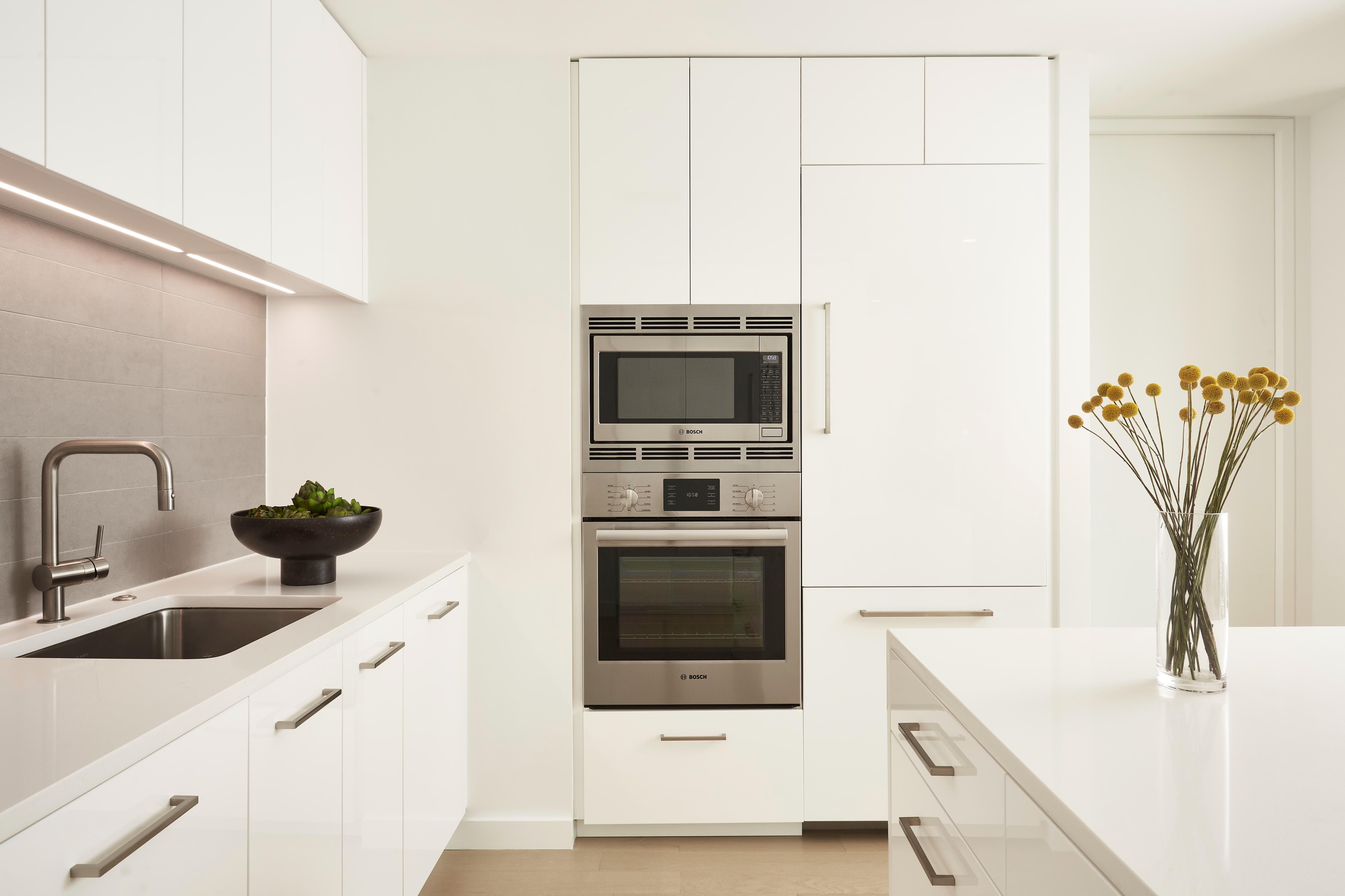 White kitchen featuring stainless steel appliances