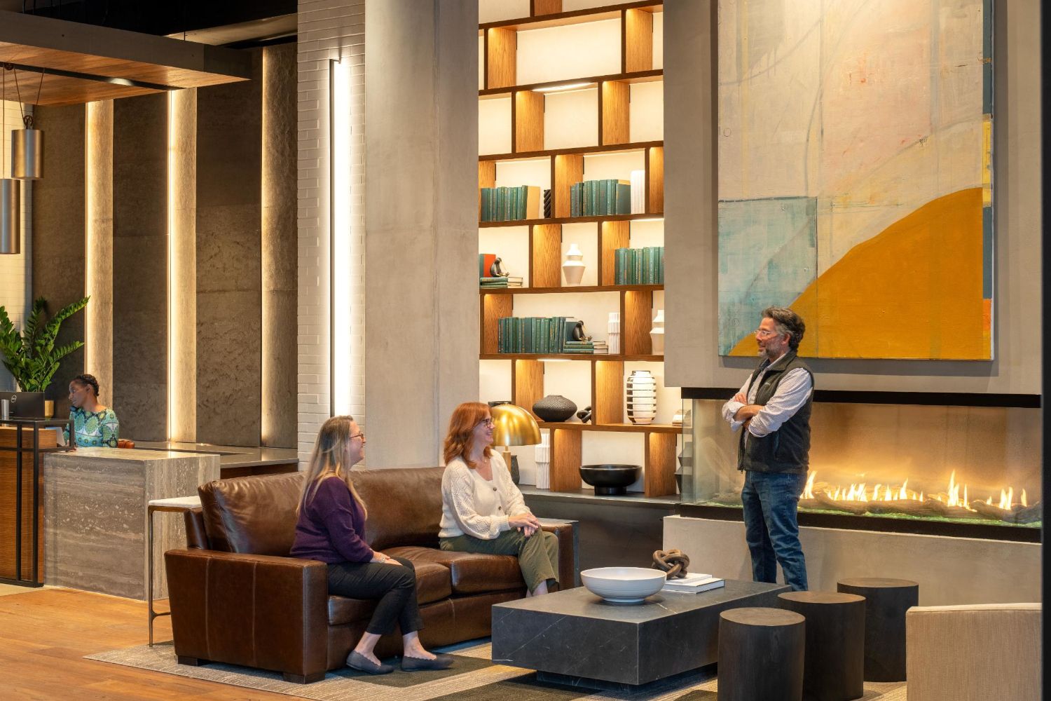 Lobby with seating, fireplace, and people
