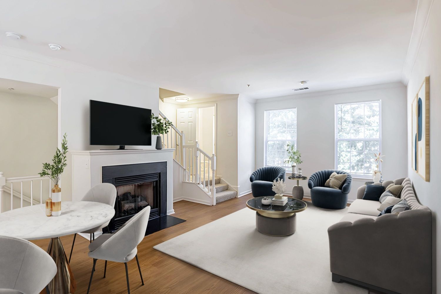 Modern living room with a TV, seating area, dining table, and neutral decor.