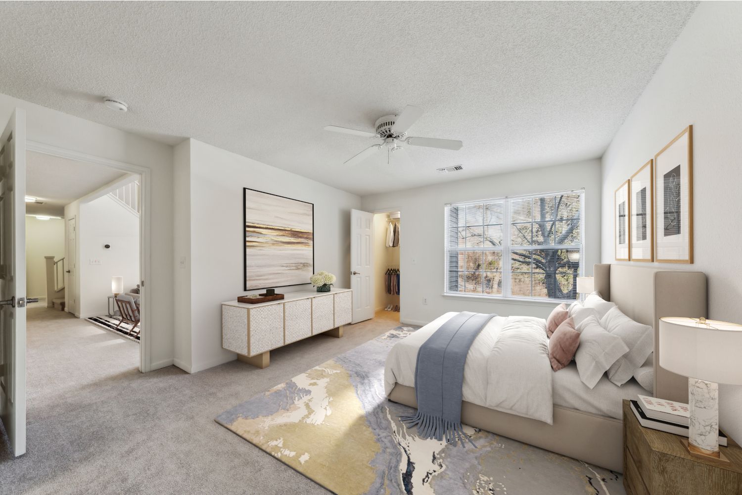 Bright, modern bedroom with a bed, artwork, and natural light.