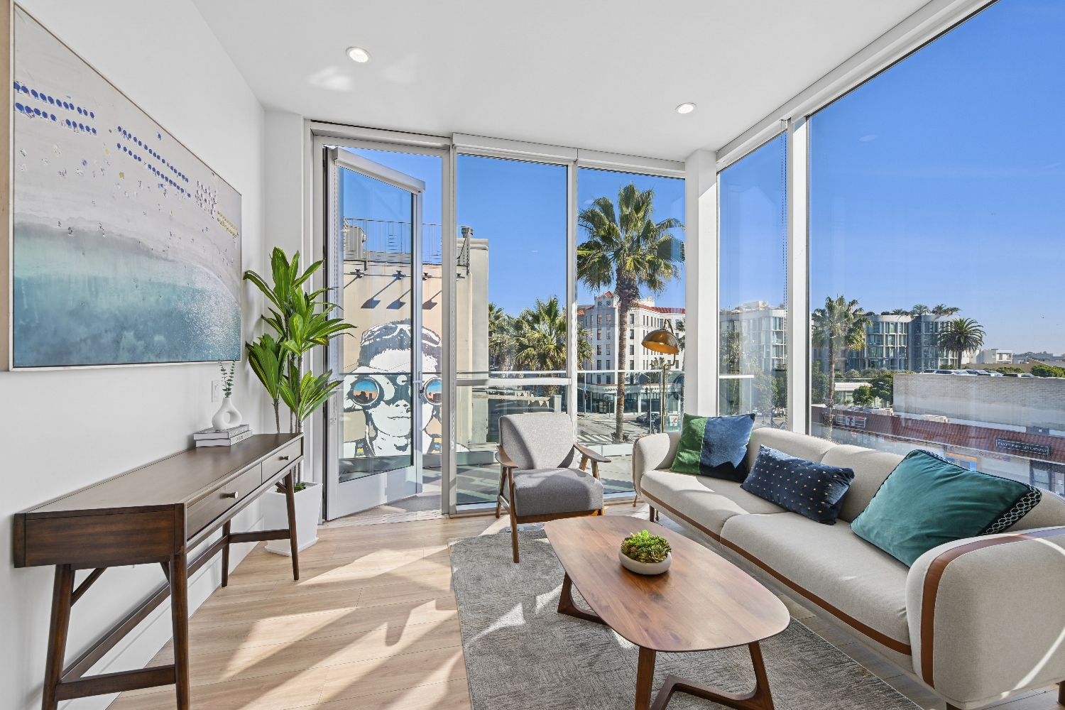 A bright living room featuring a sofa, windows, and neutral finishes.