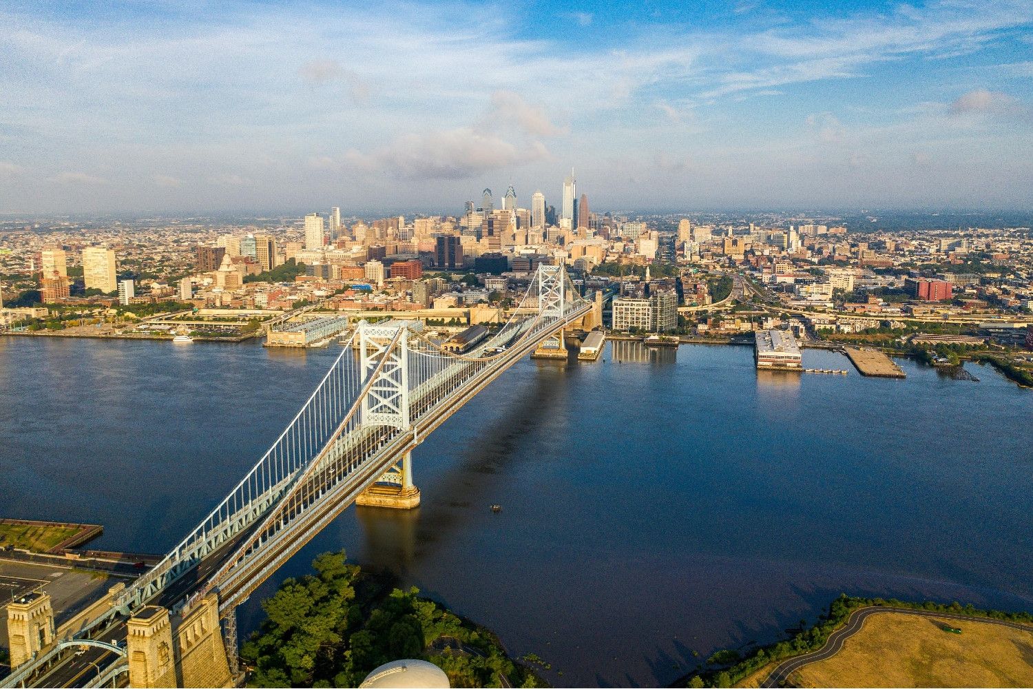 Aerial view of a city skyline with a bridge over a river.
