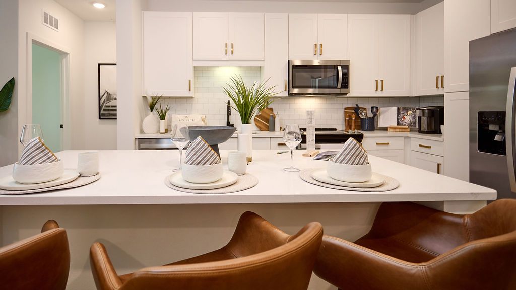 Kitchen island with place settings and leather bar stools