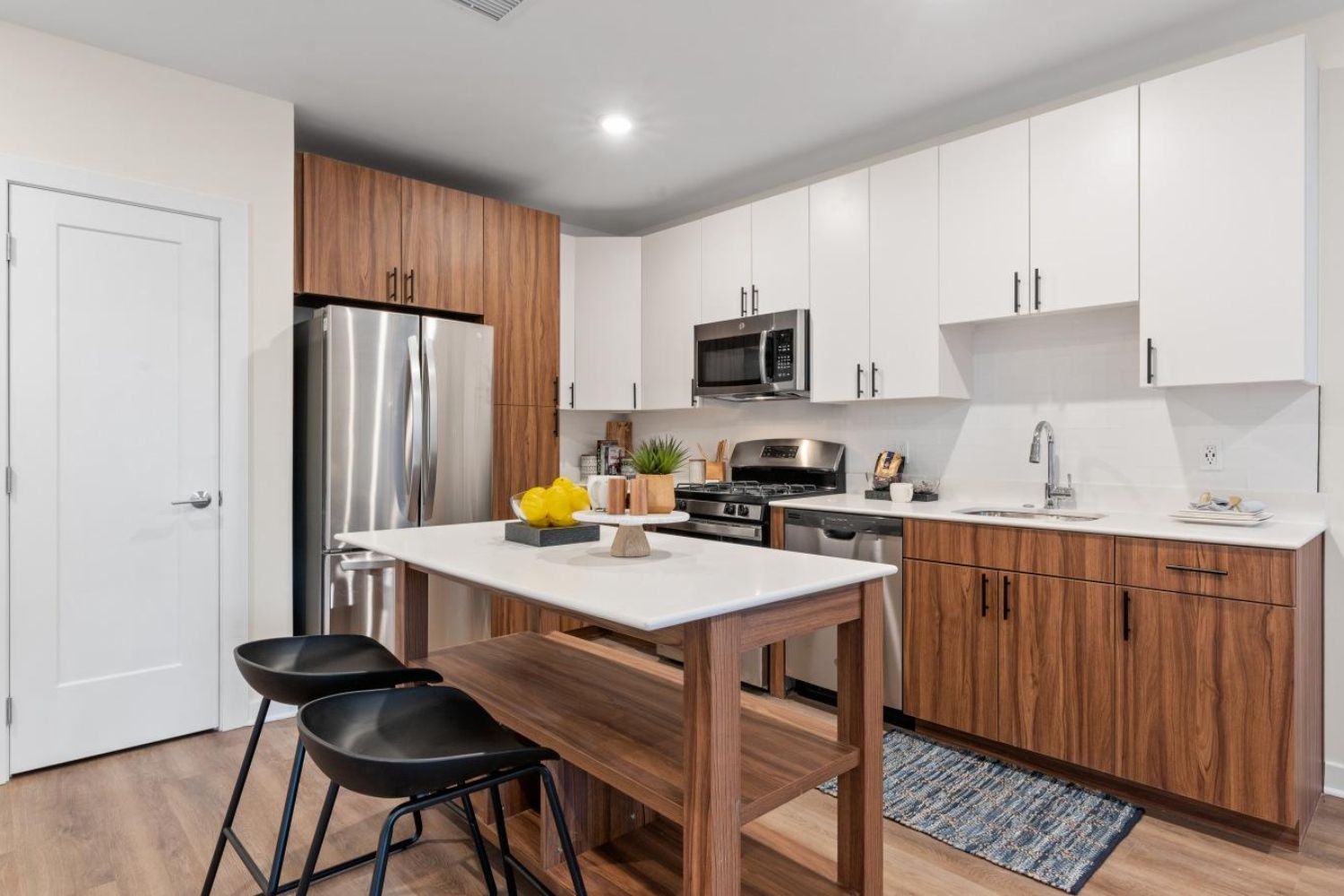 Modern kitchen with stainless steel appliances and a wood-accented island.