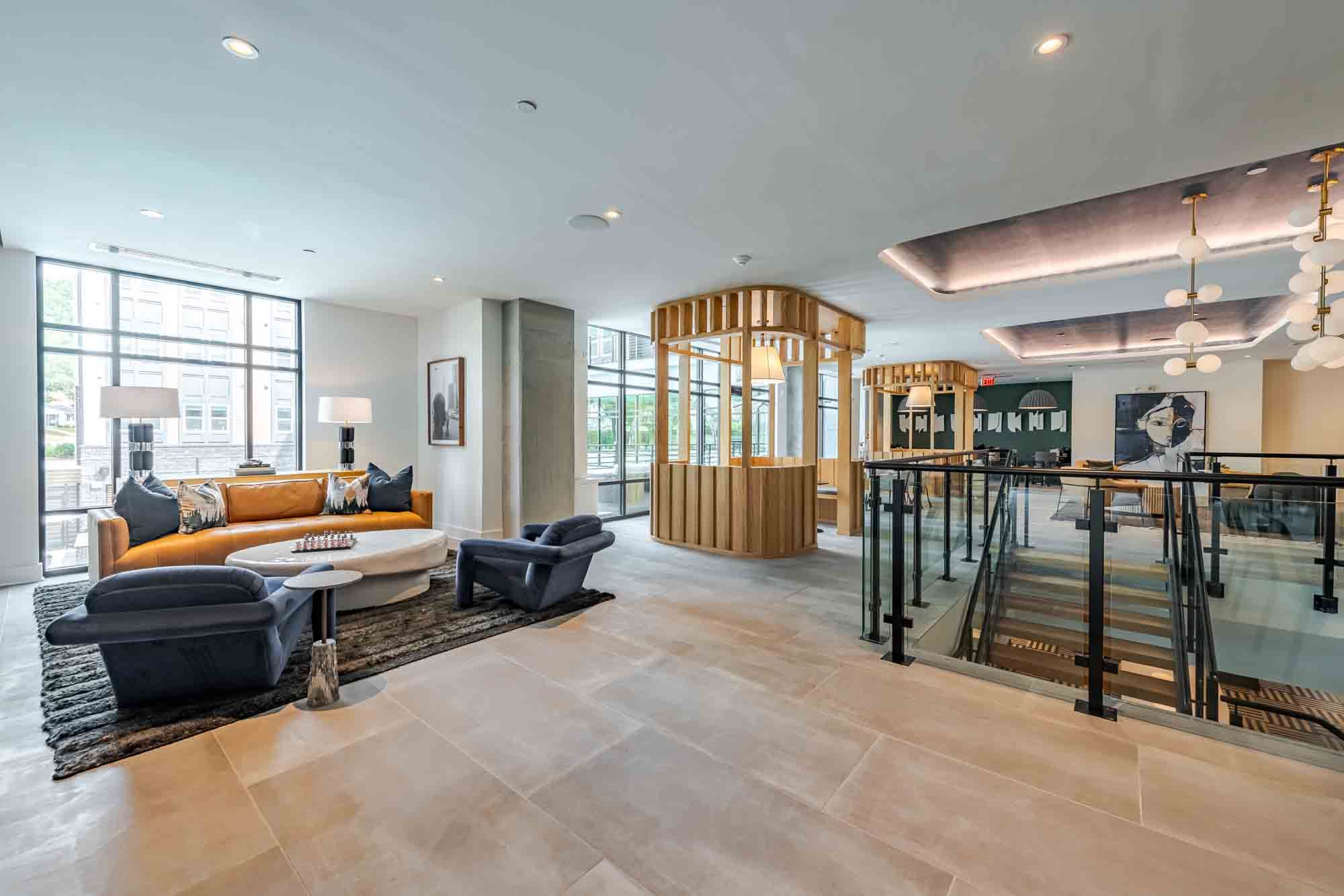 Modern interior with a bright lounge area, wood accents, and large windows.