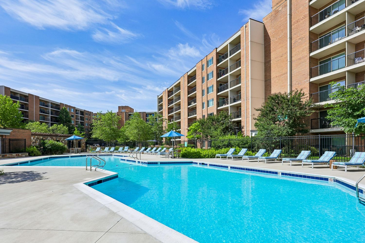 Spacious outdoor pool with an expansive sundeck, ample lounge seating, and a welcoming setting for relaxation and recreation.
