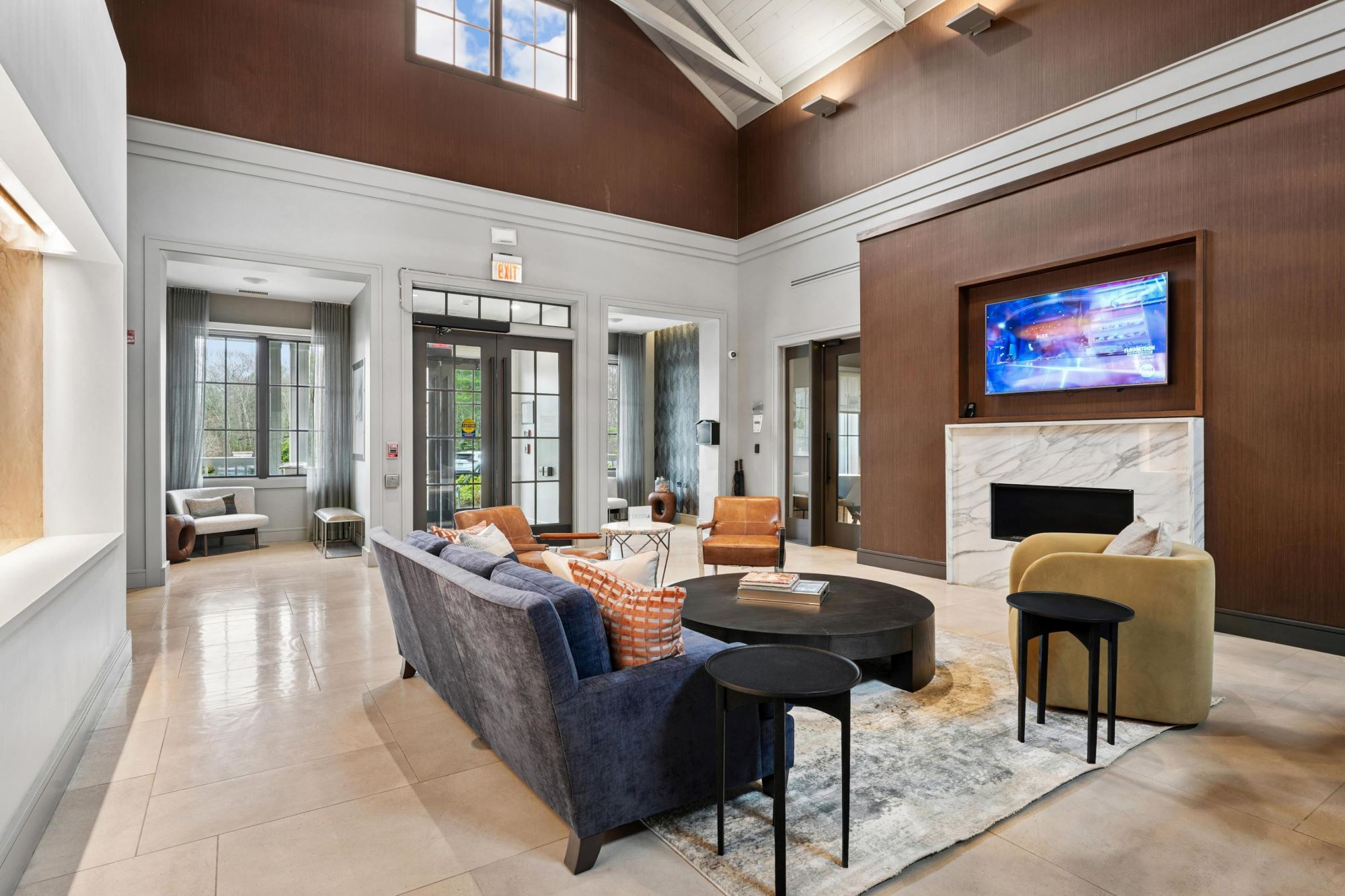 Stylish living room with modern decor, large windows, and a fireplace.