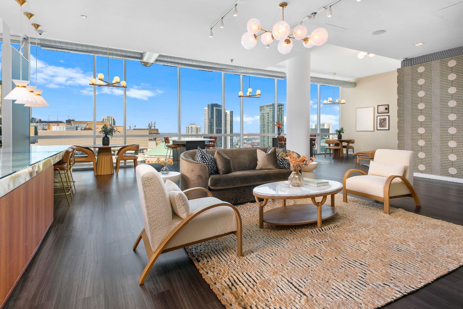 The lounge features floor-to-celing glass, allowing sunlight to fill the open-layout interior.