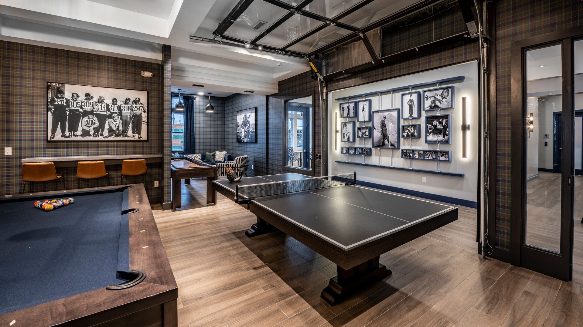 Game room featuring a ping pong table, pool table, and wall art in a modern design.