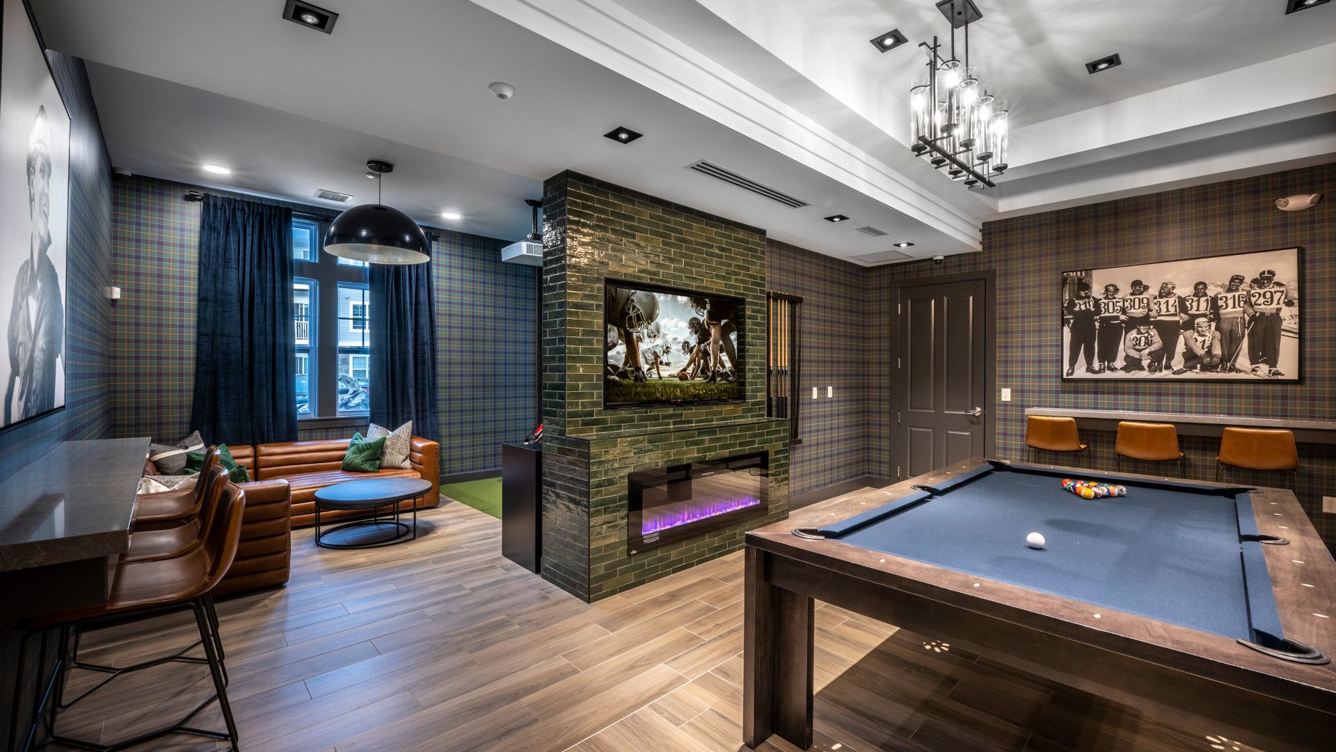 Modern game room with pool table, TV, and cozy seating.