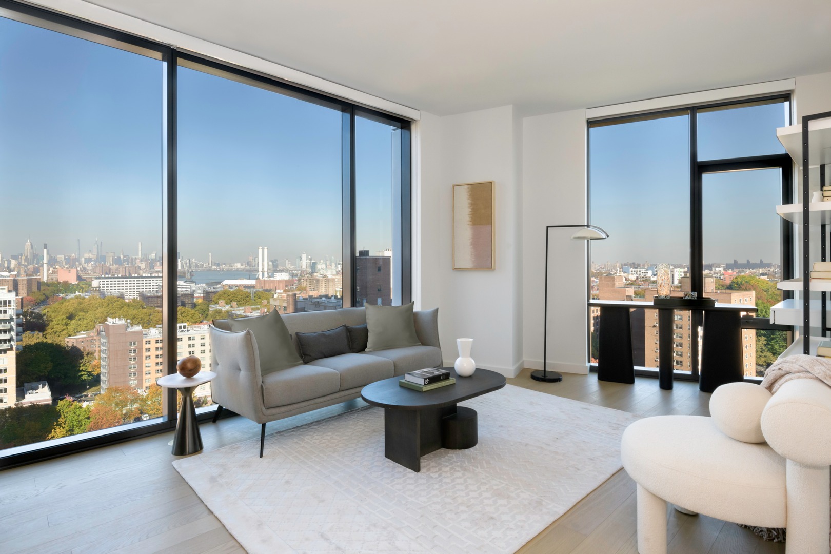 Modern living room with large windows showcasing a city view.