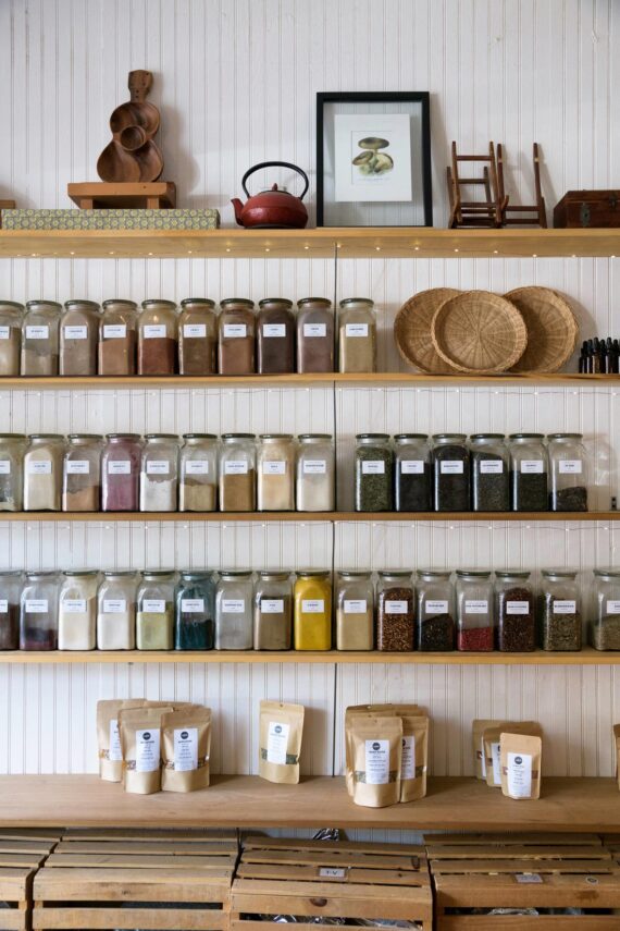 Shelves filled with labeled jars of spices and dried goods, with a few decorative items.