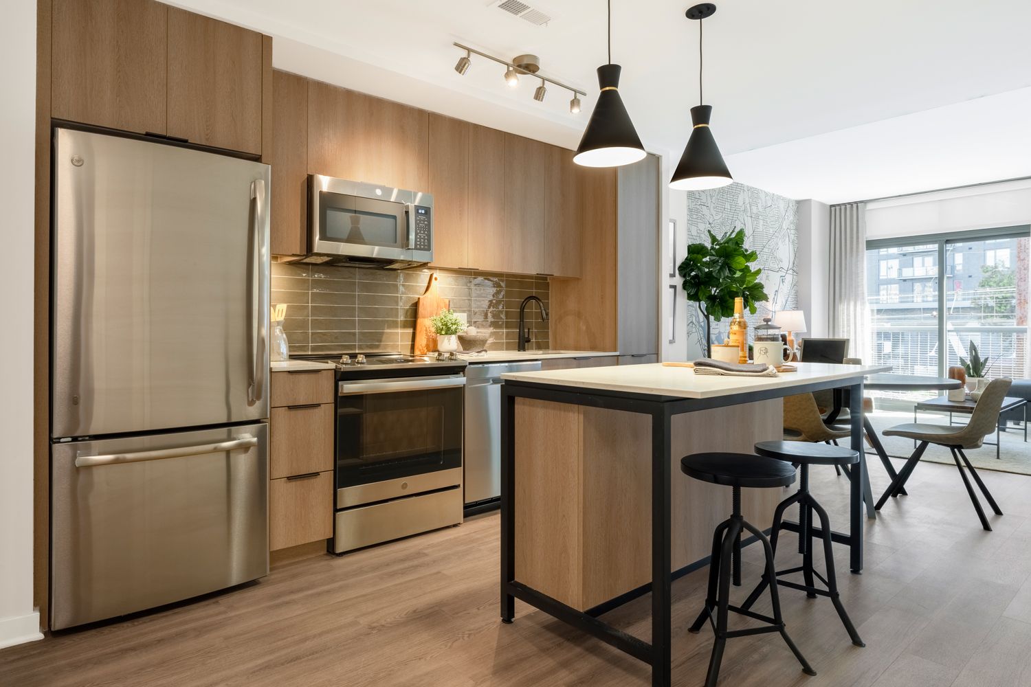 Open kitchens with state-of-the-art appliances, contemporary cabinetry and pendant lighting