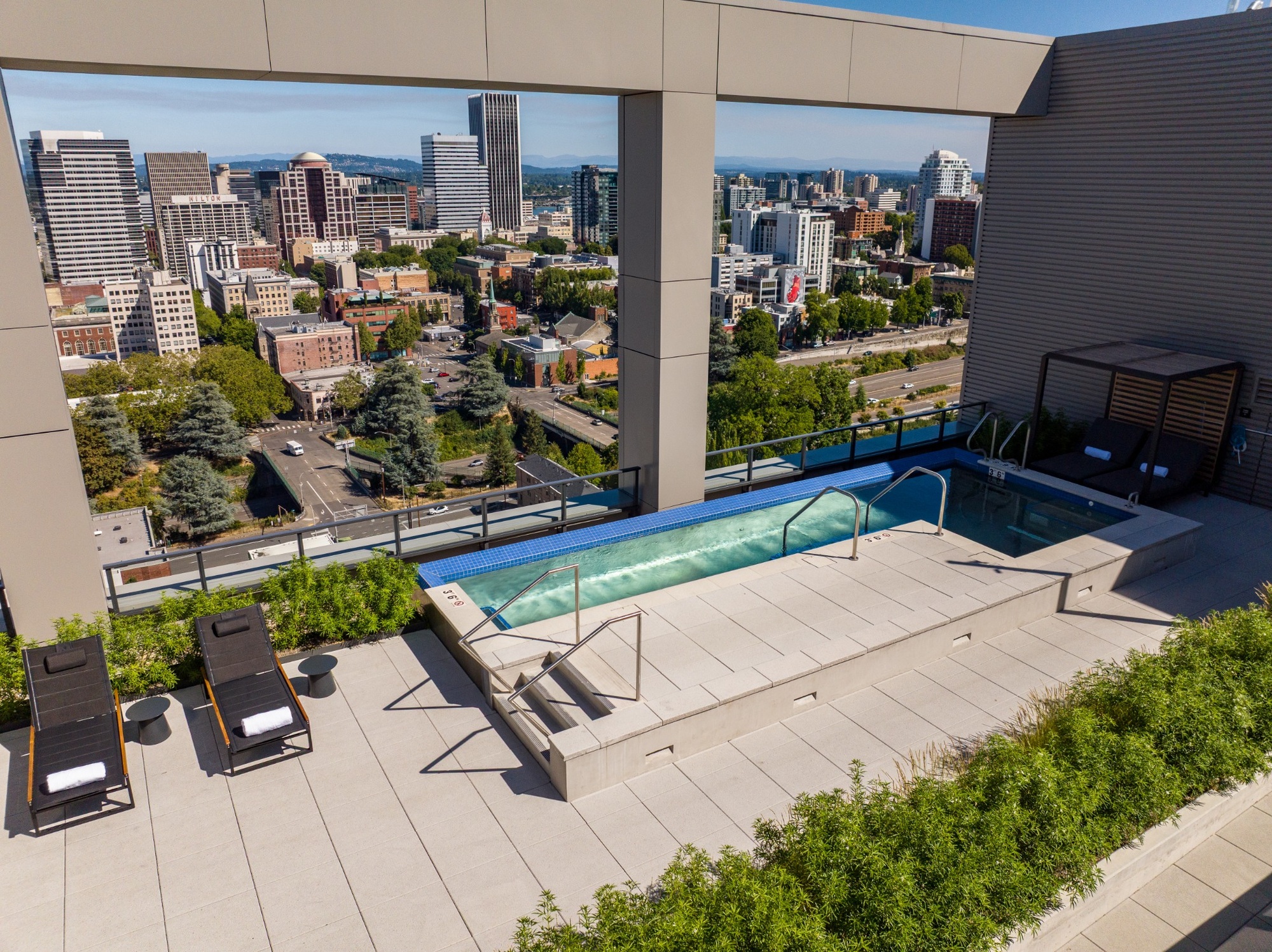 Sunset view of the rooftop spa surrounded by a planted terrace.