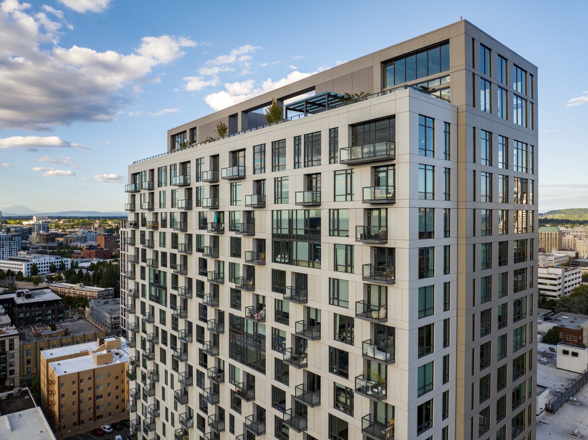 Aerial view of the Byline high-rise with balconies and cityscape.