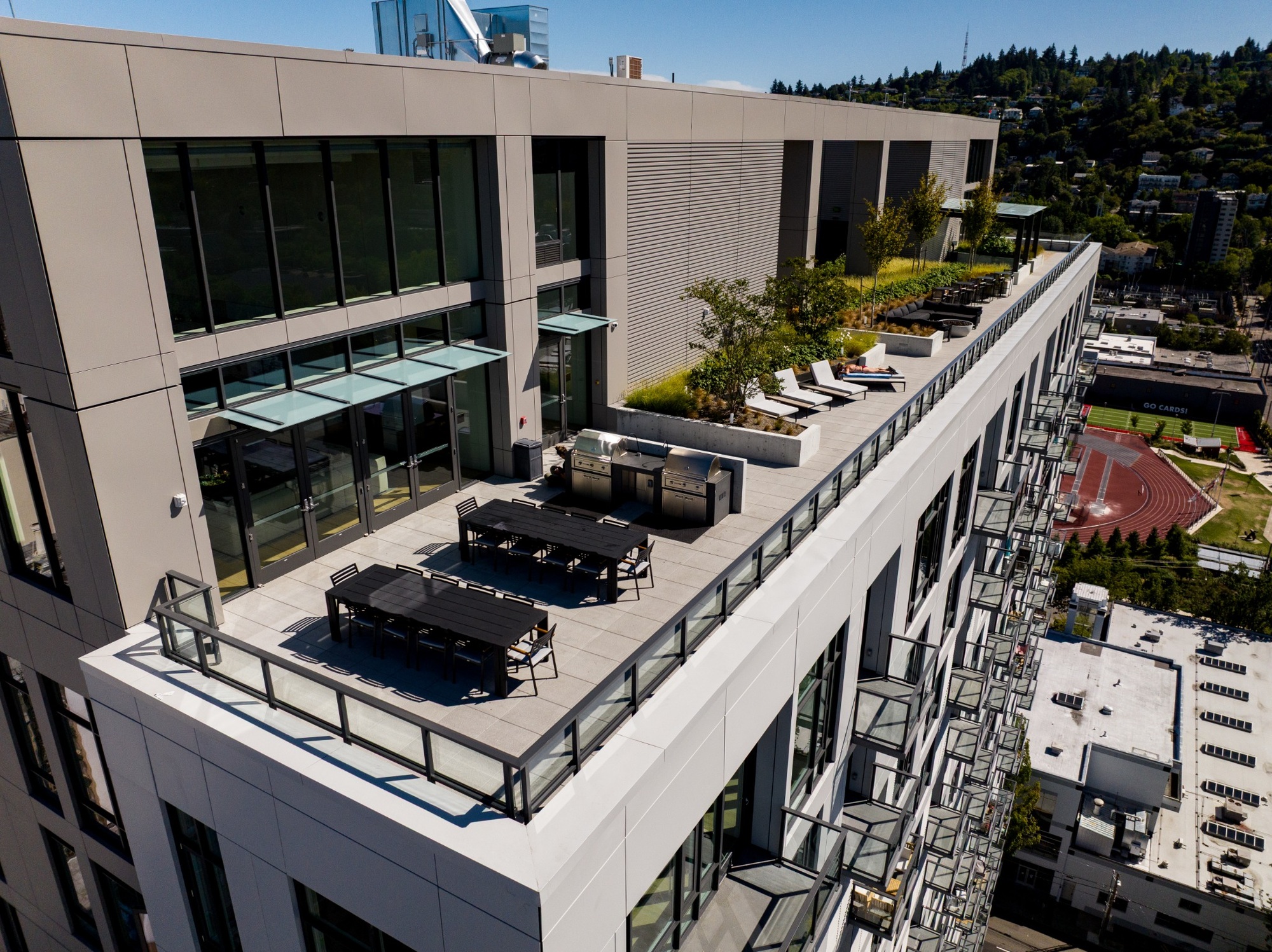 Aerial view of the rooftop deck with dining tables beside the clubroom.