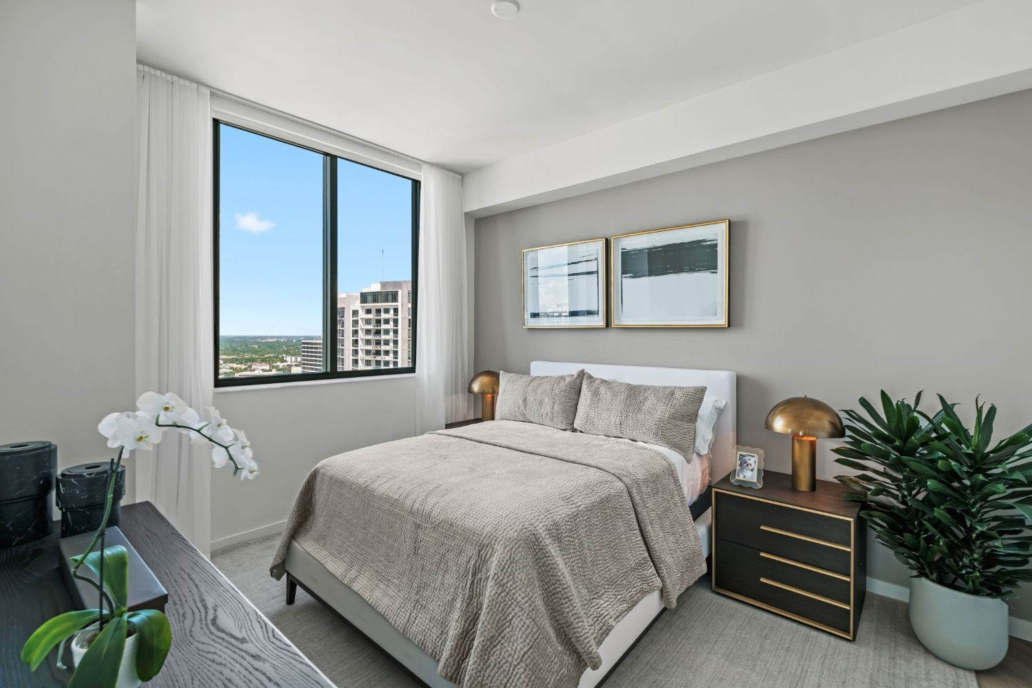 Minimalist bedroom with a bed, nightstand, and large window view.