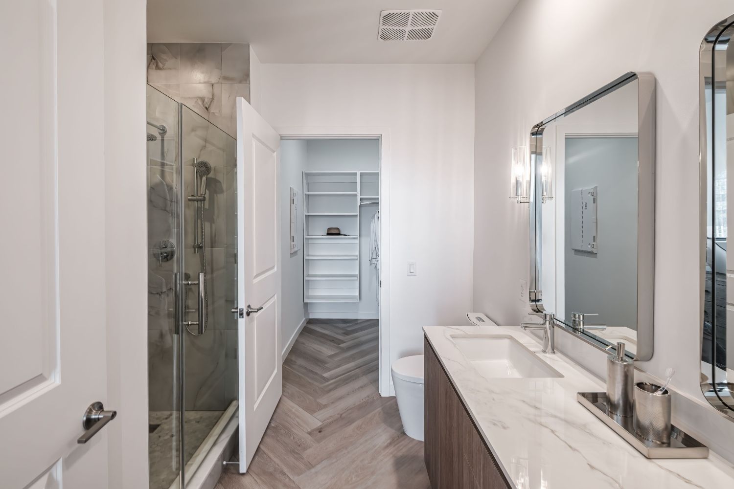 Modern bathroom with a shower, vanity, and white walls.