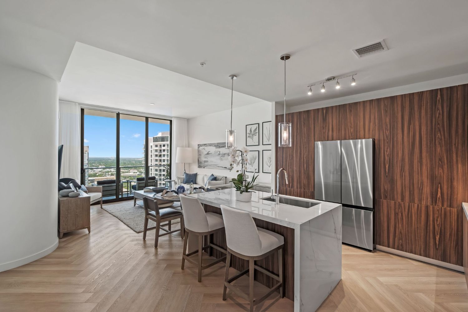 Modern kitchen with stylish cabinets, island seating, and a view of the city skyline.