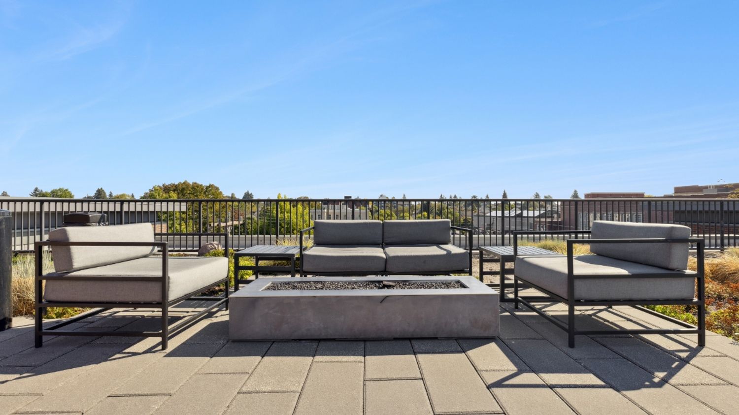 Outdoor firepit lounge on Smith & Burns rooftop overlooking Seattle skyline