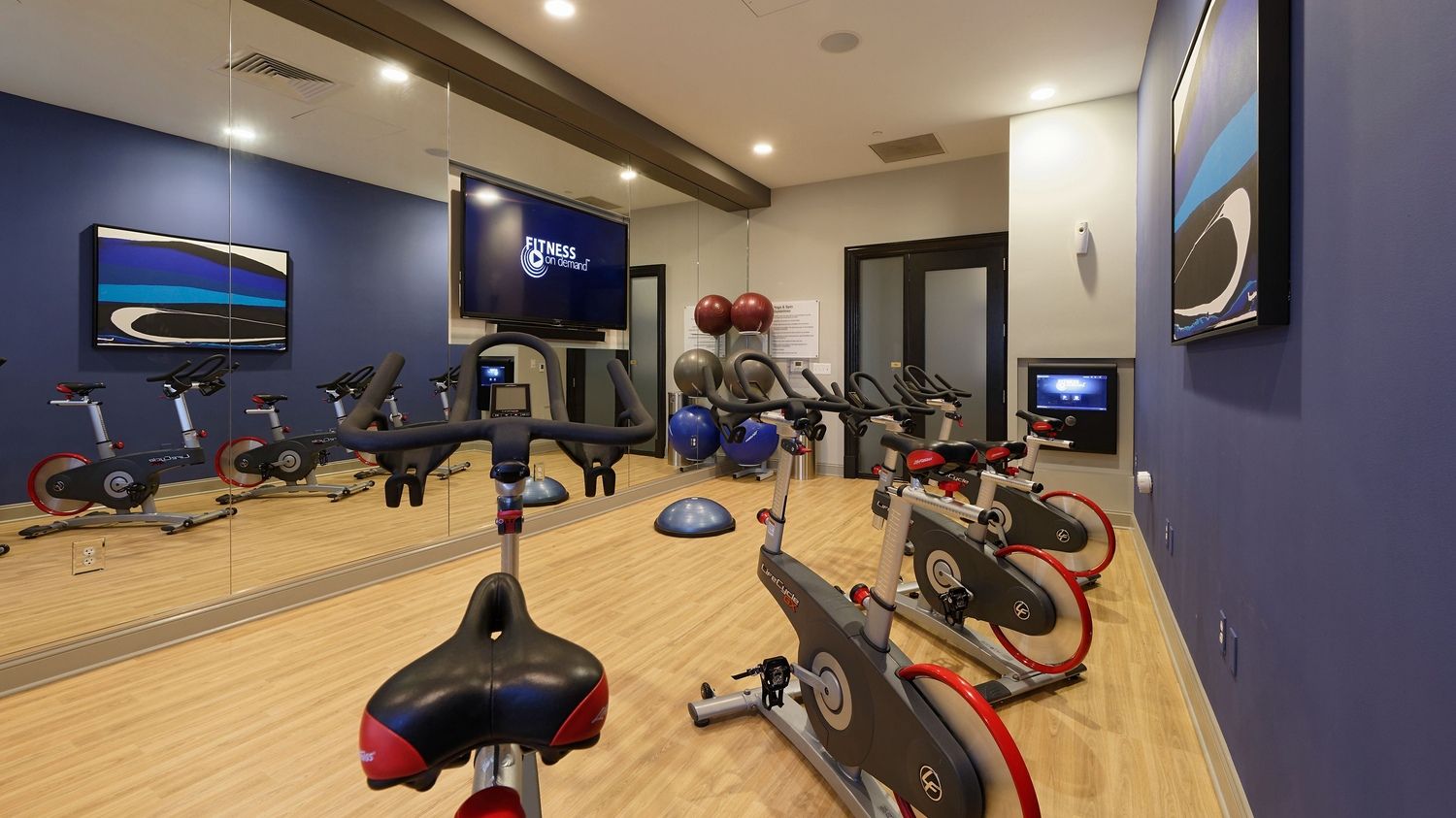 Modern fitness studio with stationary bikes and exercise equipment.